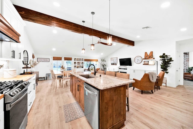 3075 Forest Hills Dr, Redding, CA 96002 - kitchen featuring stainless steel appliances, premium range hood, light wood-style flooring, recessed lighting, and a breakfast bar
