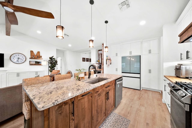 3075 Forest Hills Dr, Redding, CA 96002 - kitchen with stainless steel appliances, light wood-style flooring, white cabinetry, recessed lighting, and an island with sink