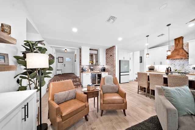 3075 Forest Hills Dr, Redding, CA 96002 - living room featuring light wood finished floors, beverage cooler, and recessed lighting