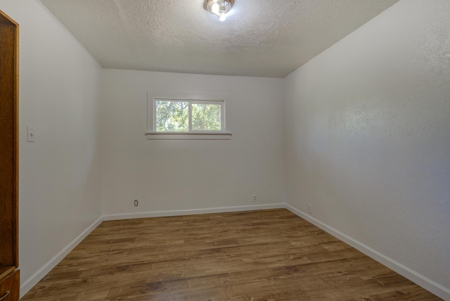 12194 Lake Blvd, Redding, CA 96001 - spare room featuring wood finished floors and a textured ceiling