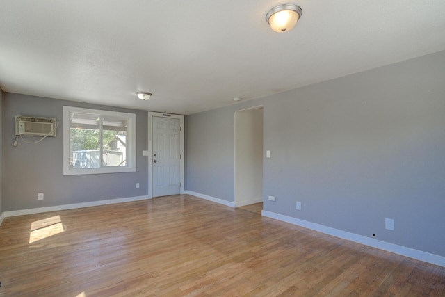 12194 Lake Blvd, Redding, CA 96001 - spare room with an AC wall unit and light wood-style flooring