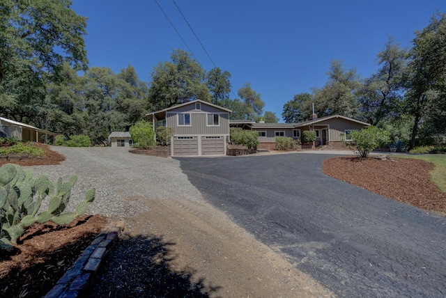 12194 Lake Blvd, Redding, CA 96001 - split level home featuring driveway, board and batten siding, and an attached garage
