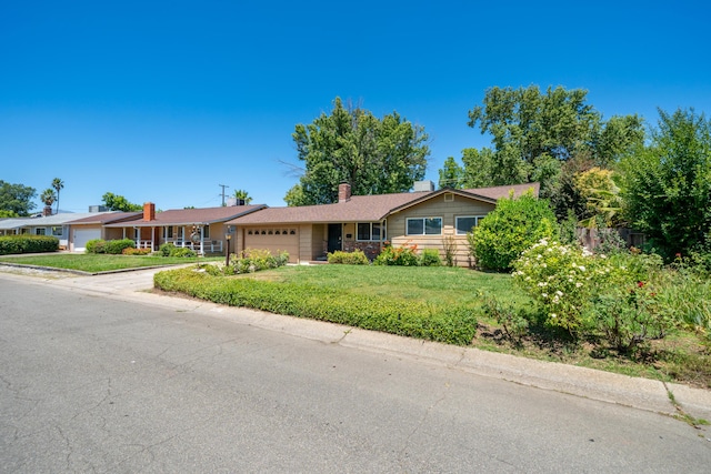 2076 Merle Dr, Redding, CA 96001 - ranch-style house featuring a garage, a front yard, driveway, and a chimney
