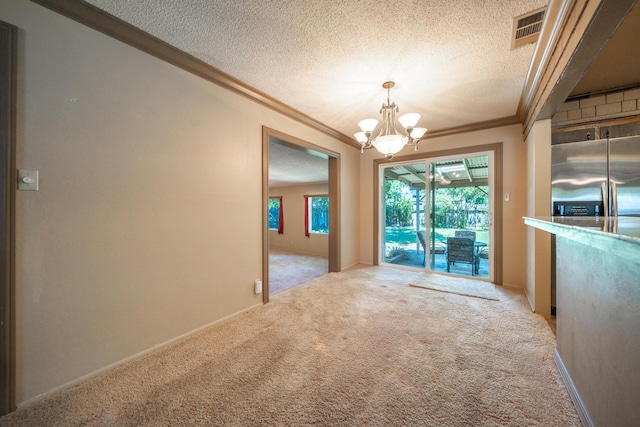 2076 Merle Dr, Redding, CA 96001 - unfurnished dining area featuring ornamental molding, a textured ceiling, carpet flooring, and a chandelier