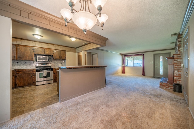 2076 Merle Dr, Redding, CA 96001 - kitchen with stainless steel appliances, a chandelier, open floor plan, a textured ceiling, and brown cabinets