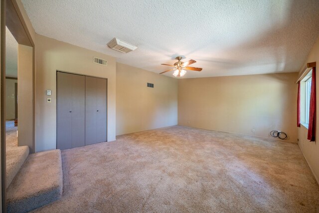 2076 Merle Dr, Redding, CA 96001 - unfurnished bedroom featuring carpet floors, a textured ceiling, a closet, and ceiling fan