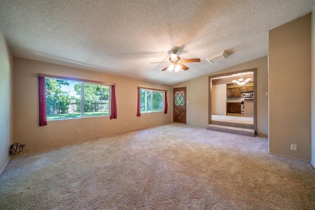 2076 Merle Dr, Redding, CA 96001 - spare room featuring a ceiling fan, vaulted ceiling, a chandelier, carpet floors, and a textured ceiling