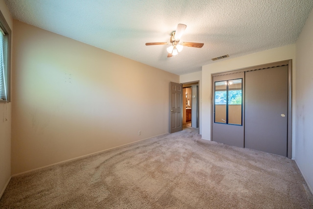 2076 Merle Dr, Redding, CA 96001 - unfurnished bedroom with carpet floors, a closet, ceiling fan, and a textured ceiling