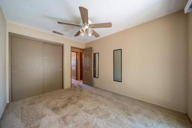 2076 Merle Dr, Redding, CA 96001 - unfurnished bedroom with carpet, a closet, a ceiling fan, and a textured ceiling