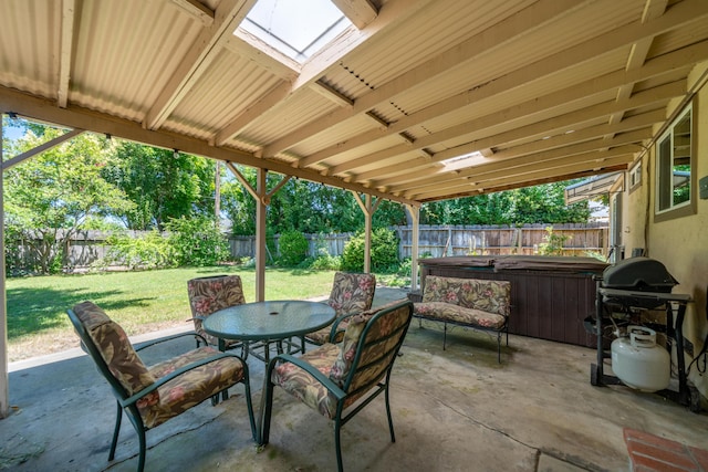 2076 Merle Dr, Redding, CA 96001 - fenced backyard featuring a hot tub, a patio, grilling area, and outdoor dining space