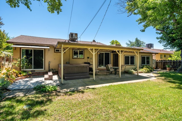 2076 Merle Dr, Redding, CA 96001 - back of house with a hot tub, a patio, and stucco siding