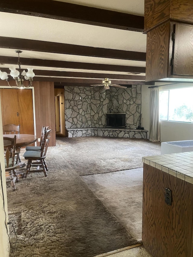 1110 Dusty Ln, Redding, CA 96002 - living area featuring carpet flooring, beamed ceiling, a chandelier, a fireplace, and ceiling fan
