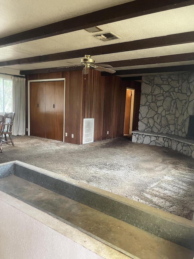 1110 Dusty Ln, Redding, CA 96002 - unfurnished living room featuring beam ceiling, ceiling fan, and wooden walls