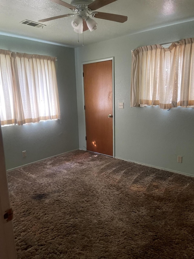 1110 Dusty Ln, Redding, CA 96002 - unfurnished room featuring carpet, ceiling fan, and a textured ceiling