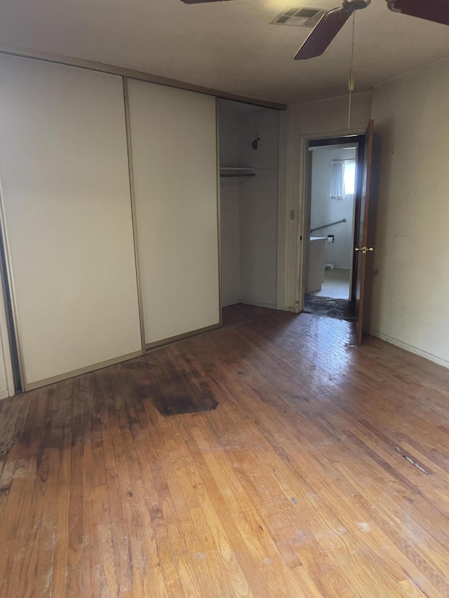 1110 Dusty Ln, Redding, CA 96002 - unfurnished bedroom featuring wood-type flooring, a closet, and a ceiling fan