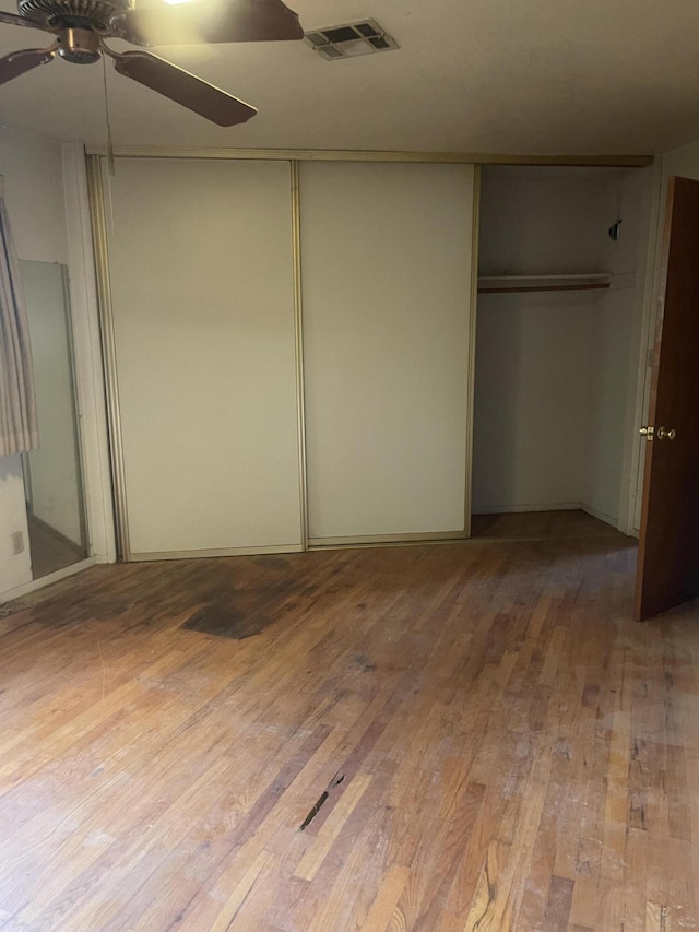 1110 Dusty Ln, Redding, CA 96002 - unfurnished bedroom with hardwood / wood-style flooring, a closet, and a ceiling fan