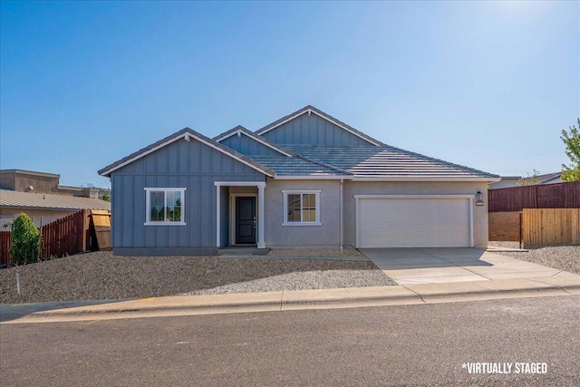 876 Wind Cove Dr, Redding, CA 96001 - ranch-style home with an attached garage, driveway, and board and batten siding