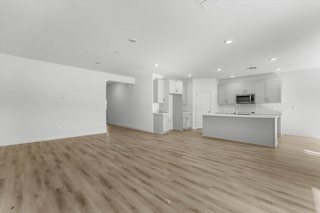 876 Wind Cove Dr, Redding, CA 96001 - unfurnished living room with recessed lighting and light wood-type flooring