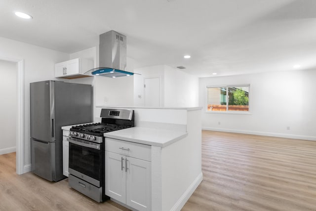 2445 Toyon St, Anderson, CA 96007 - kitchen with wall chimney exhaust hood, stainless steel appliances, light wood finished floors, light countertops, and white cabinetry