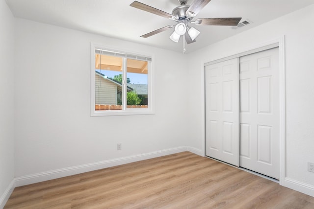 2445 Toyon St, Anderson, CA 96007 - unfurnished bedroom featuring light wood-style floors, a closet, and a ceiling fan