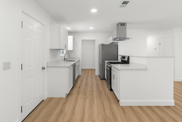 2445 Toyon St, Anderson, CA 96007 - kitchen with appliances with stainless steel finishes, island exhaust hood, light wood finished floors, light countertops, and recessed lighting