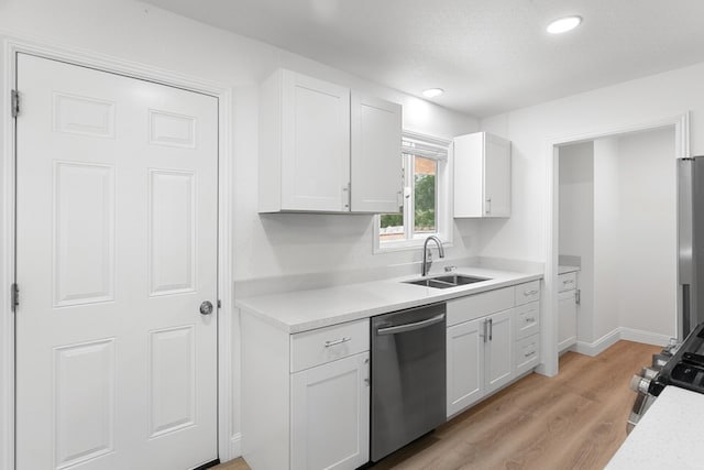 2445 Toyon St, Anderson, CA 96007 - kitchen featuring appliances with stainless steel finishes, light countertops, white cabinetry, light wood-style floors, and recessed lighting