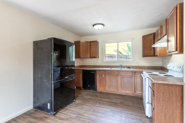1535 Provo Ave, Shasta Lake, CA 96019 - kitchen with black appliances, under cabinet range hood, dark wood-style floors, brown cabinets, and light countertops