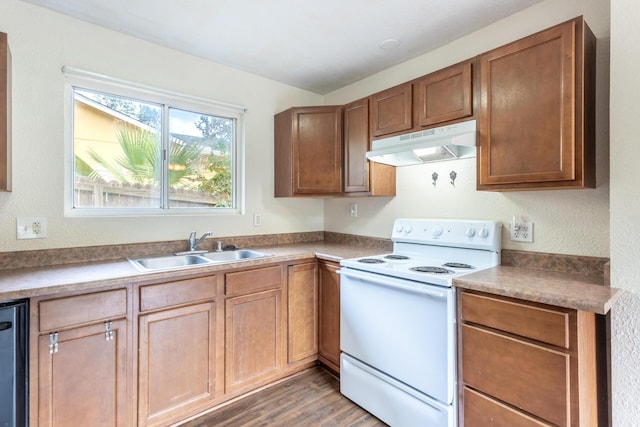 1535 Provo Ave, Shasta Lake, CA 96019 - kitchen with white range with electric cooktop, under cabinet range hood, wood finished floors, and brown cabinetry