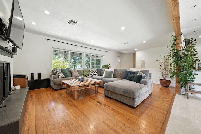 1448 Carter Way, Redding, CA 96002 - living area with light wood-type flooring, recessed lighting, and a fireplace with raised hearth