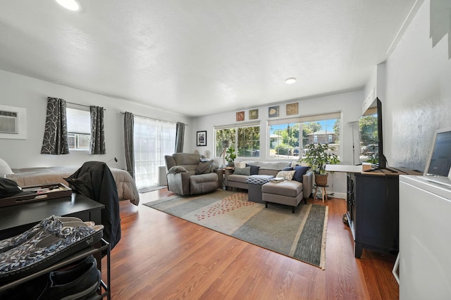 1448 Carter Way, Redding, CA 96002 - living room with wood finished floors and a wall unit AC