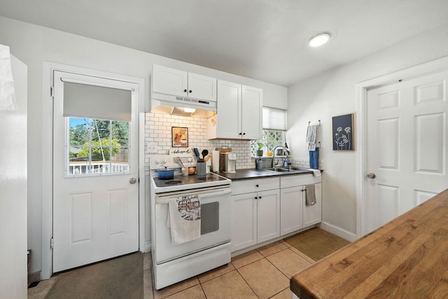 1448 Carter Way, Redding, CA 96002 - kitchen with electric stove, under cabinet range hood, white cabinetry, decorative backsplash, and light tile patterned flooring