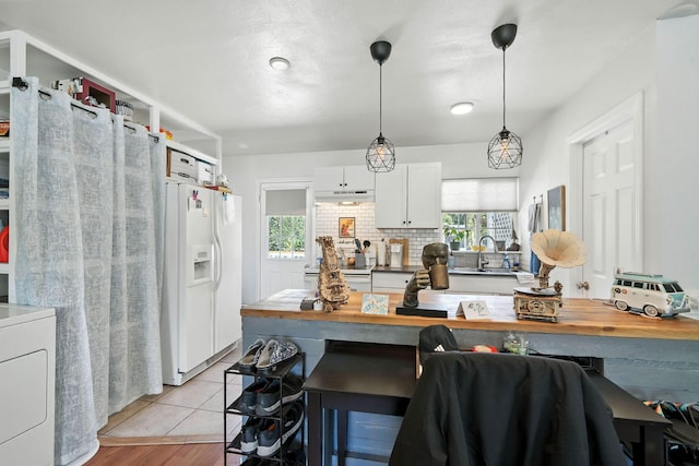 1448 Carter Way, Redding, CA 96002 - kitchen featuring white appliances, white cabinets, hanging light fixtures, decorative backsplash, and light wood-style flooring