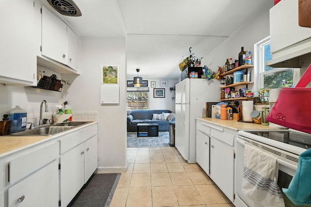 1448 Carter Way, Redding, CA 96002 - kitchen with light countertops, plenty of natural light, and white cabinetry