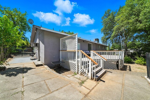 1448 Carter Way, Redding, CA 96002 - back of house with stucco siding and a deck