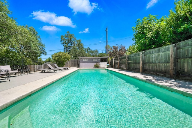 1448 Carter Way, Redding, CA 96002 - view of pool with a fenced backyard, a patio, and an outbuilding