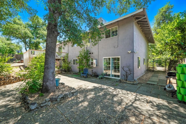 1448 Carter Way, Redding, CA 96002 - rear view of house with stucco siding, a patio, and a gate