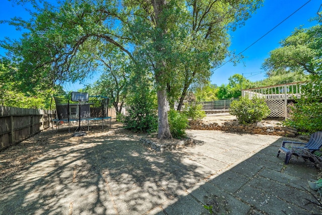 1448 Carter Way, Redding, CA 96002 - fenced backyard featuring a trampoline and a patio area