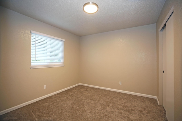 2855 Red Bud Ln, Anderson, CA 96007 - carpeted empty room featuring a textured ceiling and baseboards