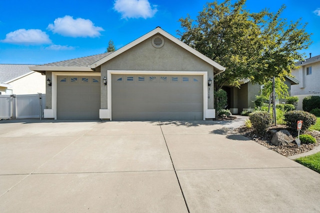 2110 Cilantro Dr, Redding, CA 96003 - ranch-style house with an attached garage, stucco siding, concrete driveway, and a gate