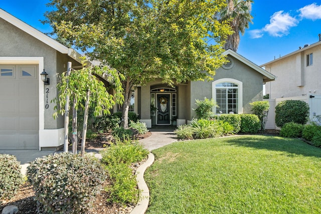 2110 Cilantro Dr, Redding, CA 96003 - view of front of property with stucco siding, a front lawn, and an attached garage