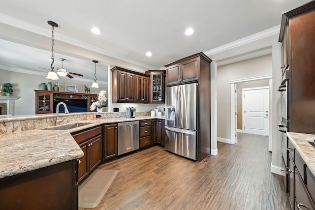 2110 Cilantro Dr, Redding, CA 96003 - kitchen featuring appliances with stainless steel finishes, dark brown cabinets, crown molding, light stone counters, and a ceiling fan