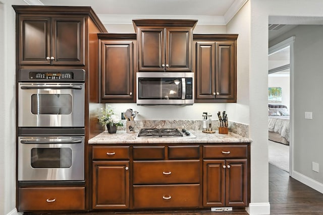 2110 Cilantro Dr, Redding, CA 96003 - kitchen with stainless steel appliances, dark wood-type flooring, dark brown cabinets, and crown molding