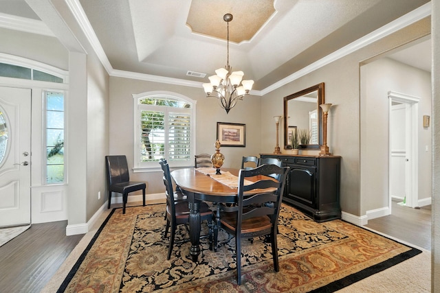 2110 Cilantro Dr, Redding, CA 96003 - dining room with a chandelier, a tray ceiling, light wood-style floors, and ornamental molding