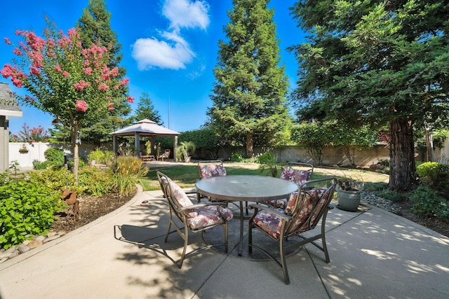 2110 Cilantro Dr, Redding, CA 96003 - fenced backyard featuring a gazebo, a patio area, and outdoor dining area