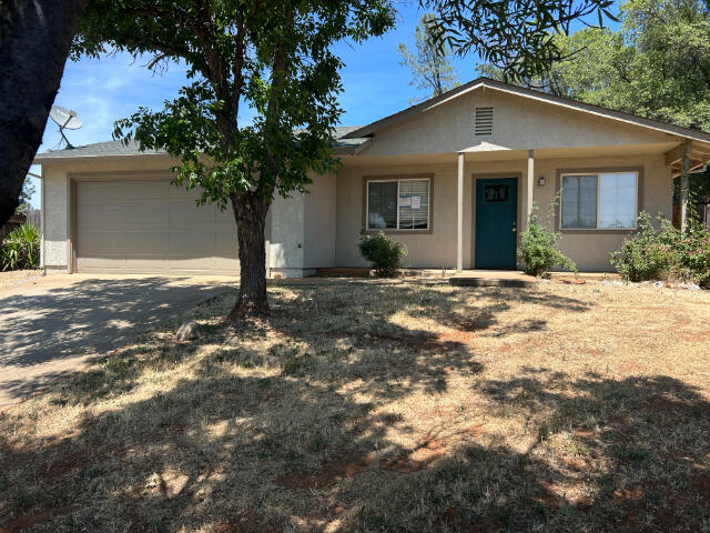 3995 Vassar Way, Shasta Lake, CA 96019 - ranch-style home with concrete driveway, an attached garage, and stucco siding