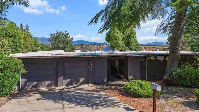 3540 Scenic Dr, Redding, CA 96001 - view of front of house featuring a mountain view, an attached garage, and driveway