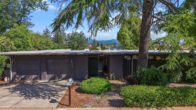 3540 Scenic Dr, Redding, CA 96001 - single story home with concrete driveway, a mountain view, and an attached garage