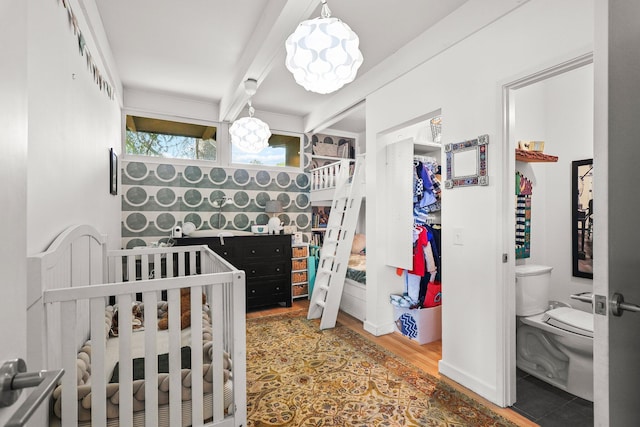 3540 Scenic Dr, Redding, CA 96001 - bedroom featuring wood finished floors, a crib, and beamed ceiling