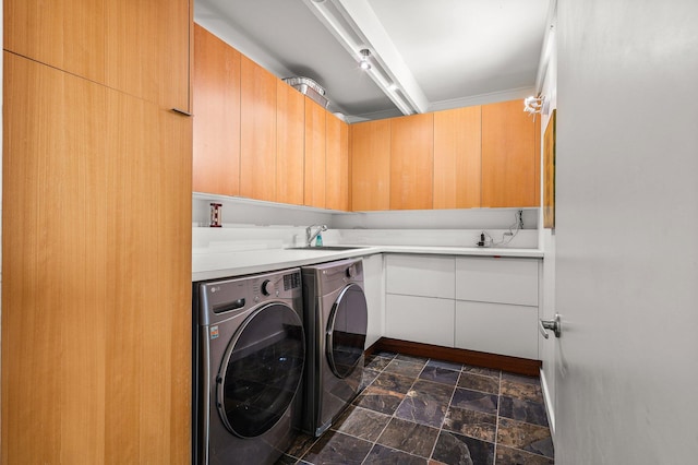 3540 Scenic Dr, Redding, CA 96001 - laundry room featuring washing machine and clothes dryer, cabinet space, and stone finish floors