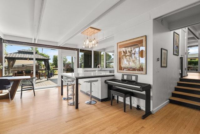 3540 Scenic Dr, Redding, CA 96001 - bar with beamed ceiling, light wood-type flooring, a chandelier, and stairway